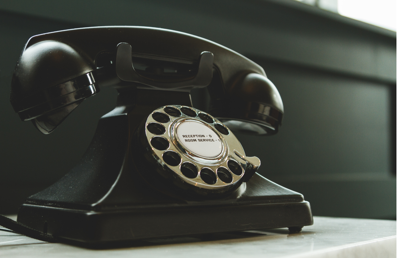 Vintage telephone on wooden table.